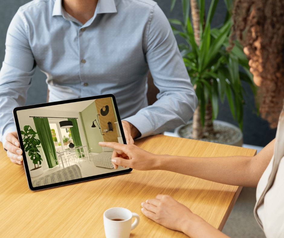 Infografista mostrando en una tableta una propuesta de interiorismo para el salón de una vivienda del Residencial Colón Infografía de J Capmany Profesional 3D