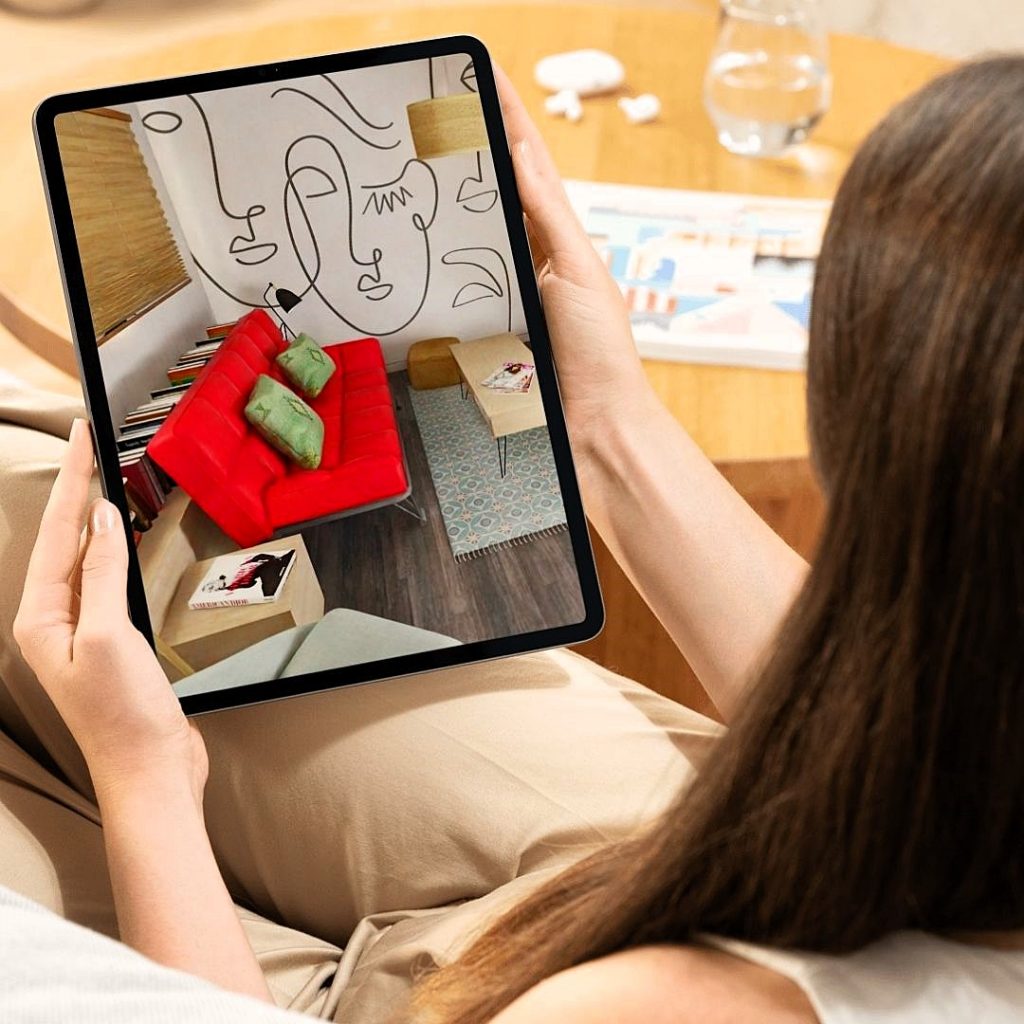 Clienta observando la infografía 3D del salón, comedor y cocina abierta tras la futura reforma de su vivienda