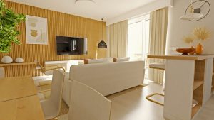 Vista panorámica de un espacio abierto moderno que integra cocina, salón y comedor con paleta neutra, madera clara y detalles decorativos en negro, iluminado por luz natural.